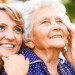 mom and daughter looking towards sky smiling