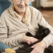 senior woman holding her pet cat