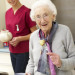 Senior woman with carergiver eating meal