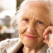 Portrait of the smiling elderly woman, sitting outside