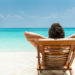 person resting in a beach chair by the shore